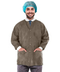 Person wearing Disposable Lab Jacket Pack Of 10 Coffee Hip Length 30 Inches Long Unisex PPE Coat With Snaps Front Knit Cuffs Collar