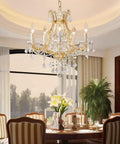 Gold 5 Light Maria Theresa Crystal Chandelier With Adjustable Chain Up To 52 Inches E12 Bulb Ready LED Compatible Modern Luxury Ceiling Fixture for Dining Room with elegant table setting.