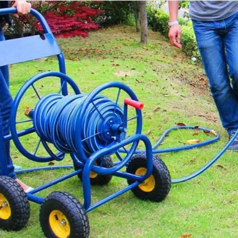 Heavy Duty Slick Metal Hose Reel With Smooth Maneuver Four Wheel Garden Cart Plus 100 Feet Water Pipe No Sweat Outdoor Setup on grass.