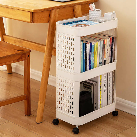 Hella Roomy Rolling Storage Organizer Cart With Smooth Plastic Shelves And Sturdy Rubber Wheels Sweet Beige Utility Shelf Rack for books beside a wooden desk.