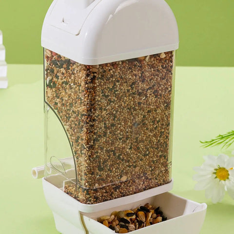 Bird Parent Approved House Shaped Automatic Bird Feeder And Water Dispenser For Parrots And Parakeets Clear large capacity feeder containing mixed seeds.