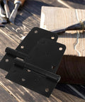 Heavy Duty Built Tough Three Point Five Inch Black Weld On Gate Hinges 2 Pack on wooden surface with tools