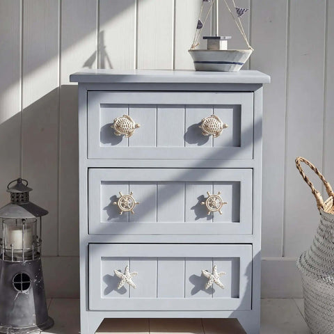 Light blue dresser with Coastal Nautical Cabinet Knobs Eight Piece Set With Starfish Sea Turtle Rudder Whale Pulls in white gold finish