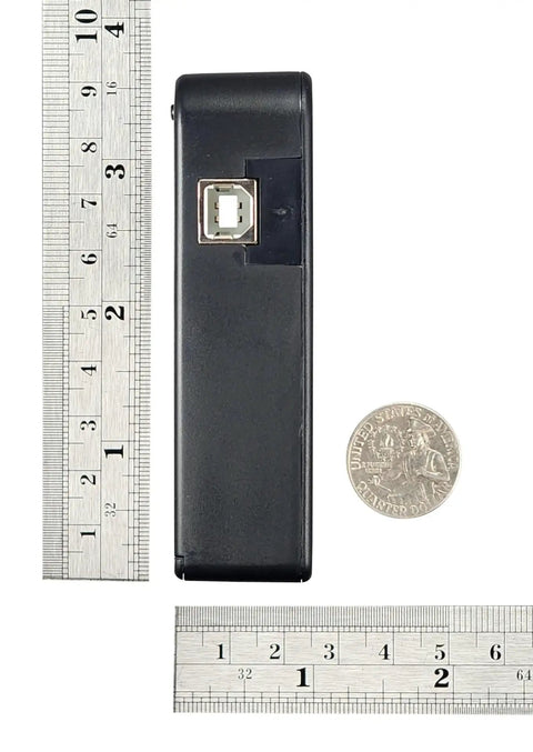 Recording Module In Black Enclosure With Dual Mode Selector Plug And Play Light Mode Or Motion Mode For Auto Display Activation By Walk By Motion Sensor Ideal For Retail Displays And Light Triggered Projects. black enclosure with USB port beside ruler and coin