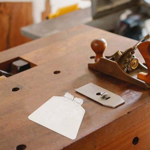 Workbench with clear rectangular tool, resembling Clear Eye Safety Guard for Bench Grinders, Easy Install Bench Cover Replacement.