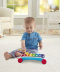 Toddler exploring Super Fun Musical Xylophone Pull Toy for Toddlers and Kiddos, Includes Mallet and 8 Colorful Keys.