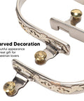 Close-up of rugged stainless steel western horse spurs with rotatable gear and carved equestrian style for men and women.