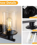 Close-up of a 4-light black bathroom vanity light fixture over mirror, showcasing glass shades and metal frame details.
