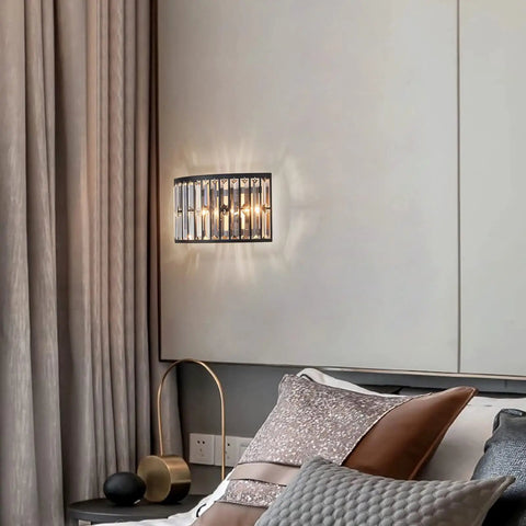 Modern K9 Crystal Wall Sconce Flush Mount LED Light With Matte Black Finish And Two Elegant Fan Shades For Bedroom Living Room Or Bathroom Decor That Is Truly High End And Straight Up Stunning mounted beside a bed.