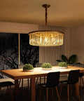 23 Inch 8 Light Modern Crystal Chandelier With Dual Gold Rings illuminating a dining room, highlighting the elegant decor