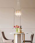 Gold Modern 3-Light Pendant Chandelier With Seeded Glass Shades in elegant dining room setting