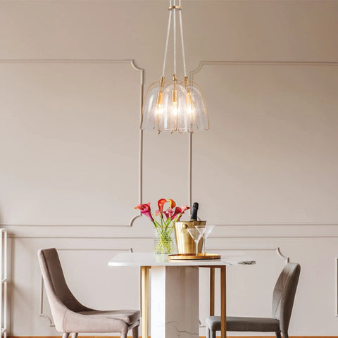 Gold Modern 3-Light Pendant Chandelier With Seeded Glass Shades in elegant dining room setting