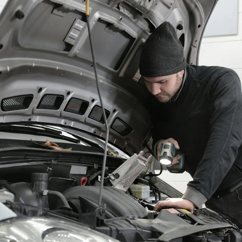 Side view of mechanic under car hood using Leberna 5–33mm stainless steel hose clamp tool kit.