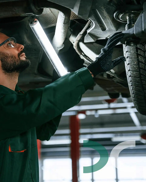 Mechanic installing 2 Inch Rear Leveling Lift Kit For Chevrolet Tahoe Suburban Avalanche 1500 2WD 4WD under a vehicle