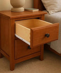 Open drawer in wooden nightstand with white 14 inch epoxy coated Euro roller drawer slides 3-4 extension heavy duty 55 lb capacity