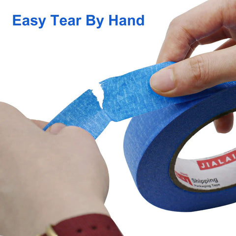 Person tearing Blue Painter Tape 1 Inch By 60 Yards Six Roll Pack Pro Grade Masking Tape For Sharp Clean Lines On Walls And Auto Surfaces