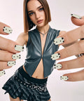 Close-up of semi cured gel nail strips and wraps 20 pack for DIY manicure with star designs, worn on hands.