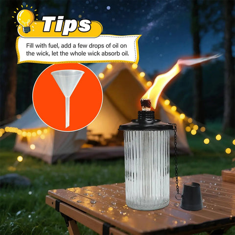 4 Pack Gray Glass Outdoor Garden Torches 59 Inch Tall With Upgraded 16 Oz Citronella Fuel 5 Prong Grounded Stake Metal Light Torches For Patio Pathway Party Decor And Create A Chill Backyard Vibe lit at night on a table with funnel and tent behind.