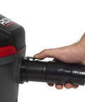 Hand connecting hose to 4-Gallon Portable Wet And Dry Vacuum Cleaner With A 5.0 Peak HP Motor, red finish, for home and garage use.