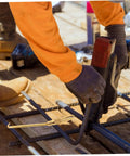 Portable Wire Tie Tool With Non Slip Handle For Quick And Easy Tying On Fences And Construction Sites in use on rebar.
