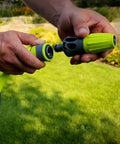 Close-up of a person holding a Garden Hose Kit With Quick Connect Attachments Lightweight Flexible Half Inch By Fifty Foot Hybrid Polymer Hose