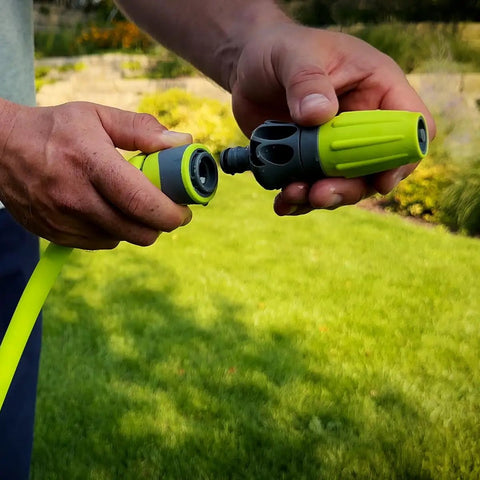 Close-up of a person holding a Garden Hose Kit With Quick Connect Attachments Lightweight Flexible Half Inch By Fifty Foot Hybrid Polymer Hose