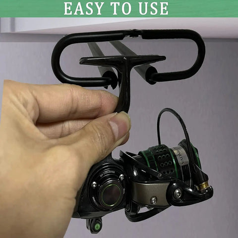 Person installing heavy duty metal fishing reel ceiling rack holds three reels