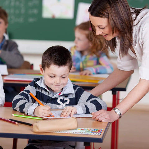 Teacher assisting student using 36 Piece Classroom Name Plates For Desks With Alphabet And Math Labels Multipurpose Manuscript Name Tags.