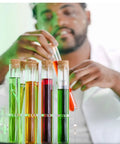 Scientist using Glass Test Tube Set, 24 Pieces, 80ml Each, with cork stoppers and a 24-hole rack, for lab experiments.