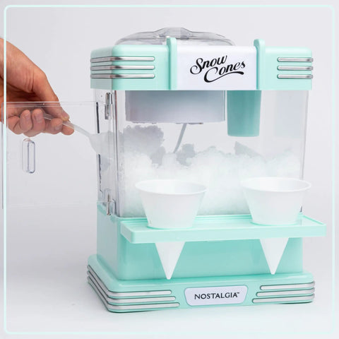 Retro Tabletop Snow Cone Machine With Two Reusable Cups And Sturdy Scoop showing ice inside and two cups ready for serving.