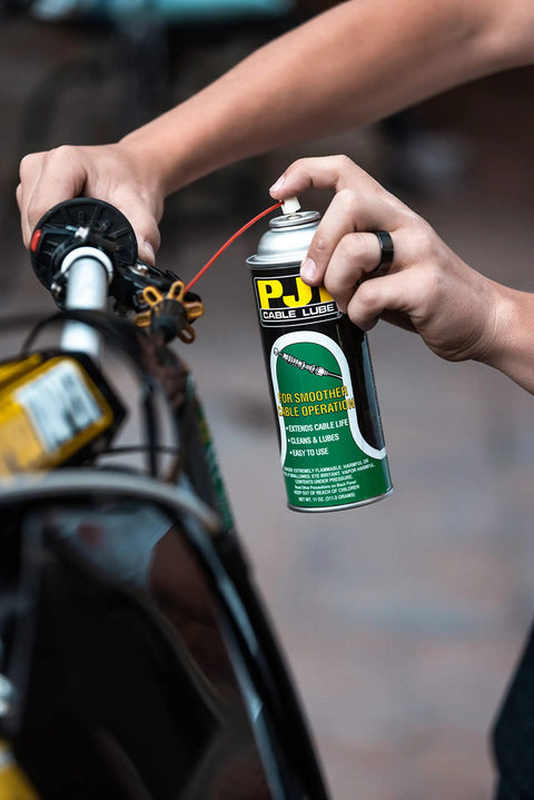 Person applying All In One Cable Lube For Bike Cables Cleans And Lubes In One Shot, Smooths Brake Throttle And Clutch Action