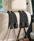 Top Shelf Universal Car Seat Headrest Hooks 2 Pack Suede Leather Bag Holders For Purses Coffee Mugs And Grocery Totes mounted on headrest.