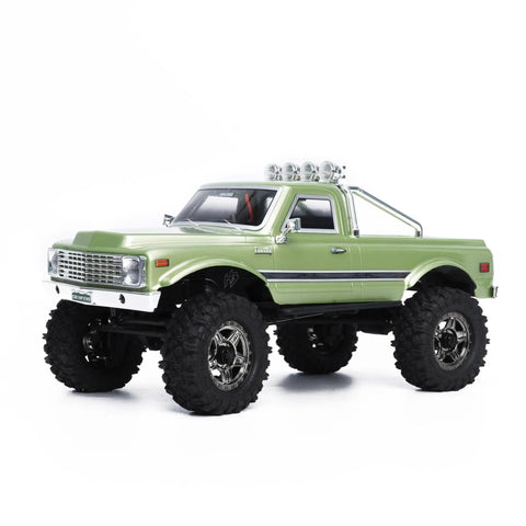 Badass 1/18 Scale RC Crawler With Slick Shifting Two Speed Transmission And Bulletproof Metal Gears Nasty Terrain Rock Climbing Rig Trail Smashin Setup Drop In Ready Convoy Medium Olive Green side view with large tires.