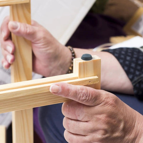 Person installing M6 thread patio levelers on wooden furniture leg for adjustable stability, part of 20 Pack M6 Thread Patio Levelers For Adjustable Furniture Feet For Garden Chairs Tables Cabinets And Bar Stools Screw In Leveling Feet With Slip Resistant Bottom And Durable Metal Construction.