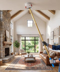 Person using Heavy Duty Smoke Alarm Removal Tool With Extended Telescoping Aluminum Pole For High Vaulted Ceilings to reach a ceiling smoke detector.