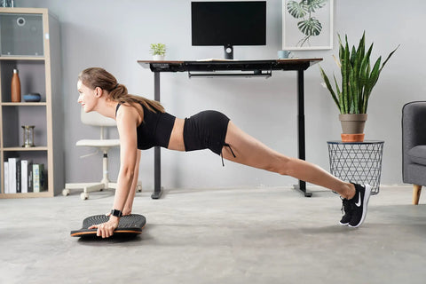 Woman exercising on All Day Comfort Standing Desk Balance Board Mat For Anti Fatigue Relief At Home And Office Wobble Board Obsidian Black