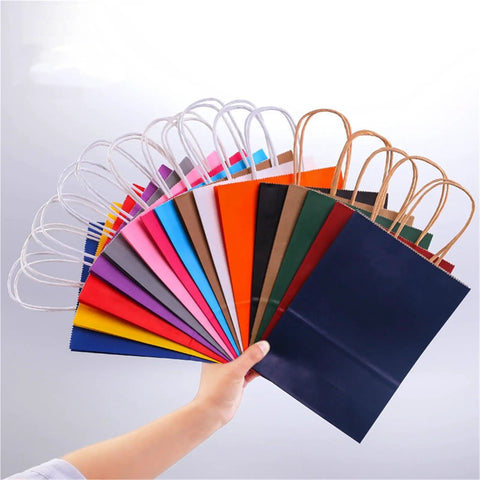 Colorful Handle Kraft Paper Bags Set 50 Or 100pcs For Shopping Hauls, Weddings, And Party Packaging Durable Carry Bags With Handles 32x11x27 Cm Eco Friendly Reusable Gift Bags displayed in fan arrangement in hand
