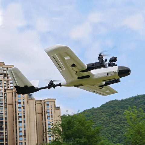 ZOHD Altus 980mm Wingspan Twin Motor V Tail EPP FPV RC Airplane flying outdoors near buildings and green hillsides.