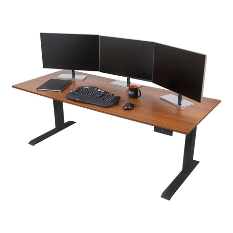 Heavy Duty Electric Standing Desk With Programmable Memory, Smooth Dual Motor Height Lift, Sturdy 3 Stage Telescoping Legs, Matte Black Frame And Warm Teak Surface, 72 Inch Flex Office Setup with dual monitors and keyboard.