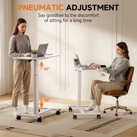 Two women using Adjustable Pneumatic Standing Desk On Wheels With Lockable Casters Mobile Laptop Desk Overbed Bedside Table For Home Office 28 Inch Wide By 16 Inch Deep White, showing height range.