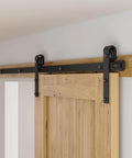 Close-up of a 5 Foot Sliding Barn Door Hardware Kit For 26 To 30 Inch Wide Single Door Matte Black Track System With J Shape Rollers.