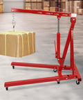 No Sweat Lifting Weights With This 2 Ton Folding Engine Hoist And Shop Crane lifting a cardboard box in a warehouse setting.