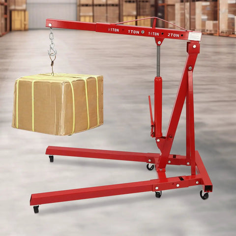 No Sweat Lifting Weights With This 2 Ton Folding Engine Hoist And Shop Crane lifting a cardboard box in a warehouse setting.