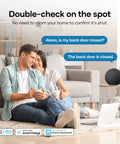 Couple enjoying coffee at home with Zigbee door sensor, checking security via Alexa integration for safety.