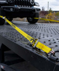 Complete Axle Strap Tie Down Kit With Wire Hook Ratchet Straps In Classic Yellow securing vehicle on trailer