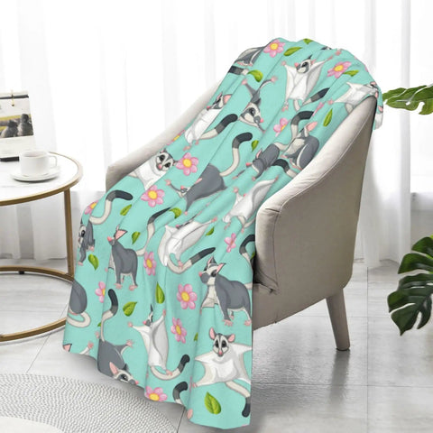 Super Cute Sugar Glider Throw Blanket For Kids And Girls, Hella Soft Weightless Plush Blend draped on a chair with colorful design.