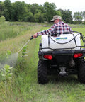 Man using 25-Gallon Deluxe UTV And ATV Spot Sprayer With 2.2 GPM Pump, 70 PSI Max, Deluxe Adjustable Spray Gun on an ATV