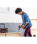 Person using 20V Max Matrix Cordless Drill And Driver Kit With Battery Included for DIY project in a workshop.