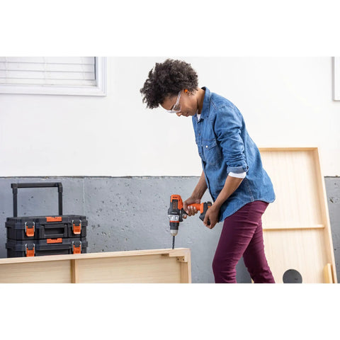 Person using 20V Max Matrix Cordless Drill And Driver Kit With Battery Included for DIY project in a workshop.
