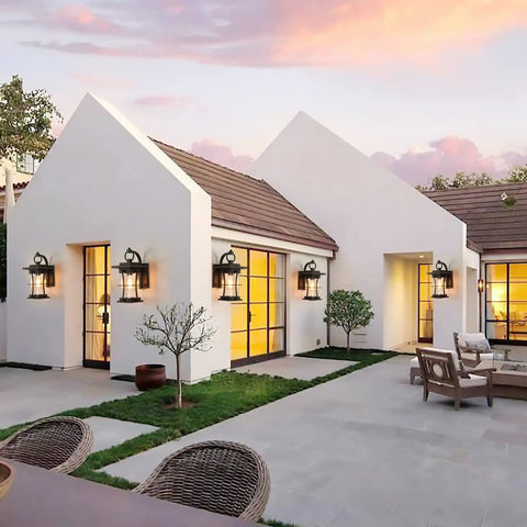 Dusk To Dawn Outdoor Wall Light With Photocell Sensor and seeded glass illuminating a modern house exterior at sunset.